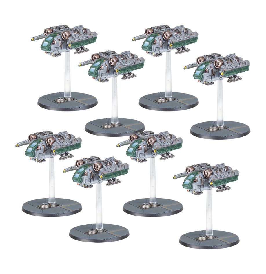 Set of warhammer model tanks on stands against a white background